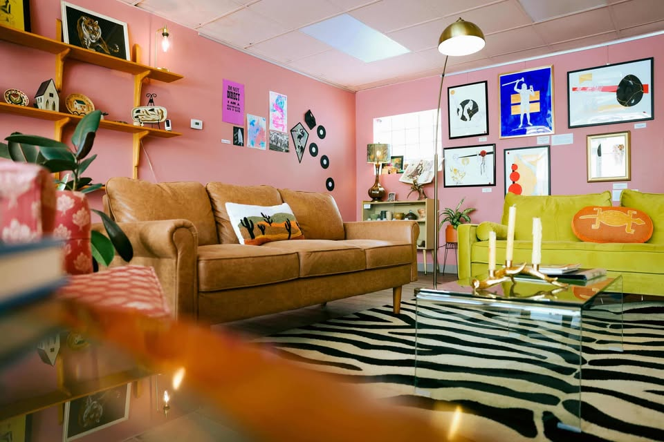 Lounge area with leather couch, mustard sofa, and zebra rug