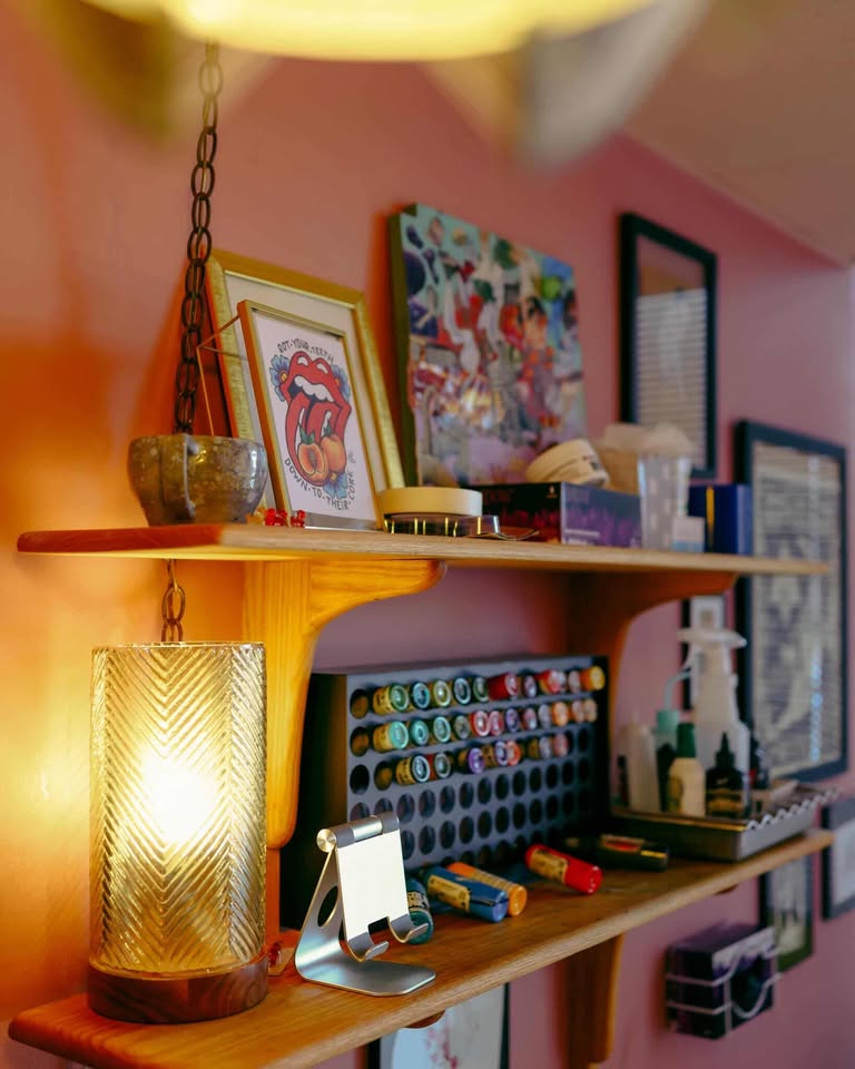 Studio shelf with plants, books, and decorative objects
